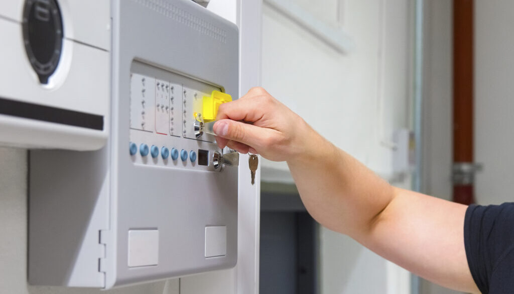 Close-up of Service Technician Opening Fire Panel In Server Room