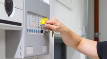 Close-up of Service Technician Opening Fire Panel In Server Room